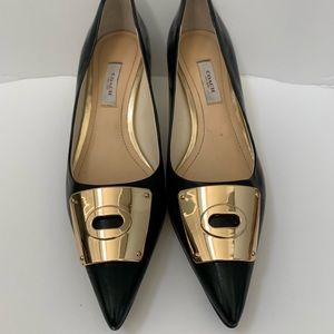 Coach Size 7 pointy toed black low heeled pumps.
